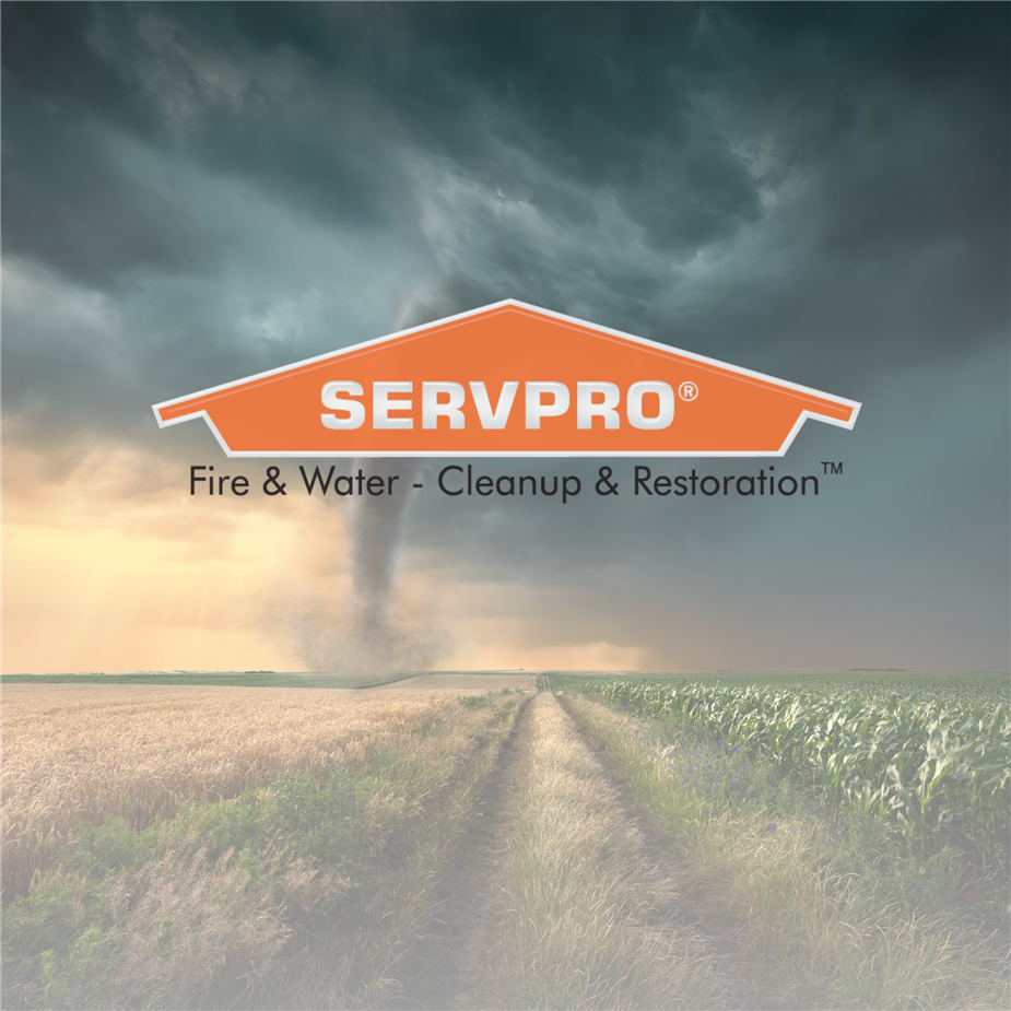 TORNADO GOING THROUGH A FIELD WITH THE SERVPRO LOGO OVER TOP